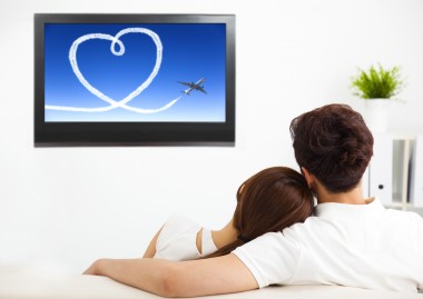 young couple watching the tv show in living room